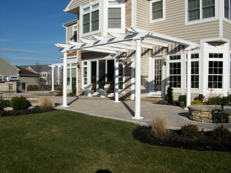 backyard patio with slide shade pergola